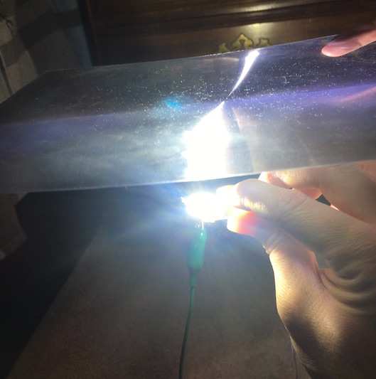 5W LED (very bright) being held under a Fresnel lens from my last post. I'm holding by the alligator clip since it's very hot.