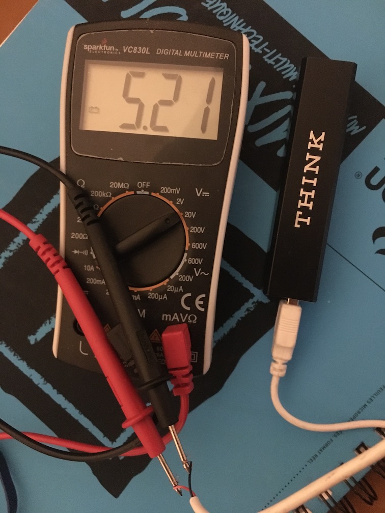 A multimeter measuring my portable phone battery's voltage
