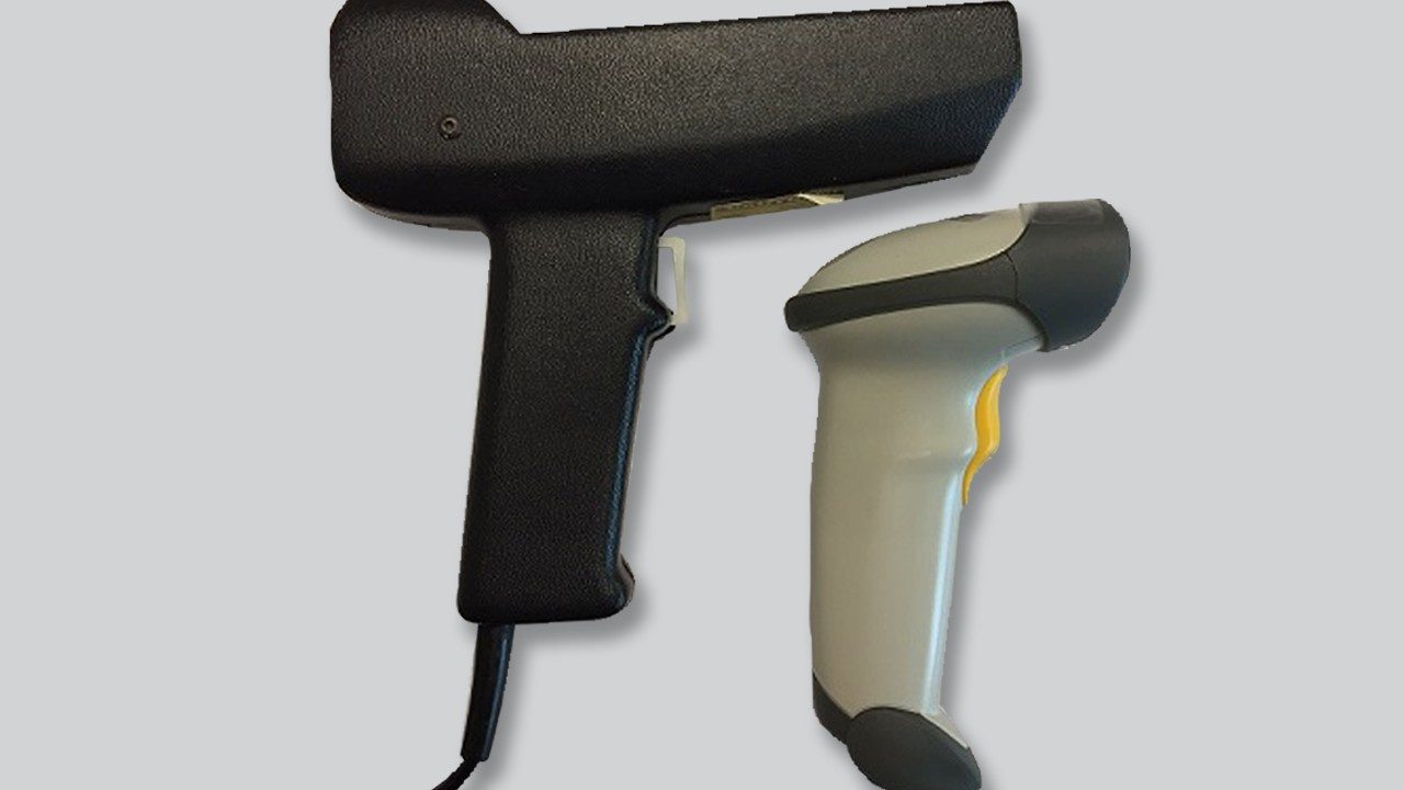 Original LS1000 barcode scanner versus modern day barcode scanners. The laser tube in the LS1000 is horizontal and takes up most of the length, while the laser diode powering the 2nd is smaller than your pinky.