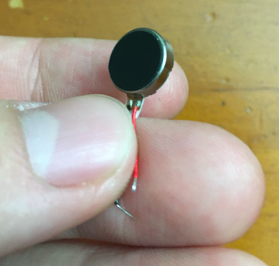 Me holding one of the tiny coin vibration motors I ordered, foamy side up