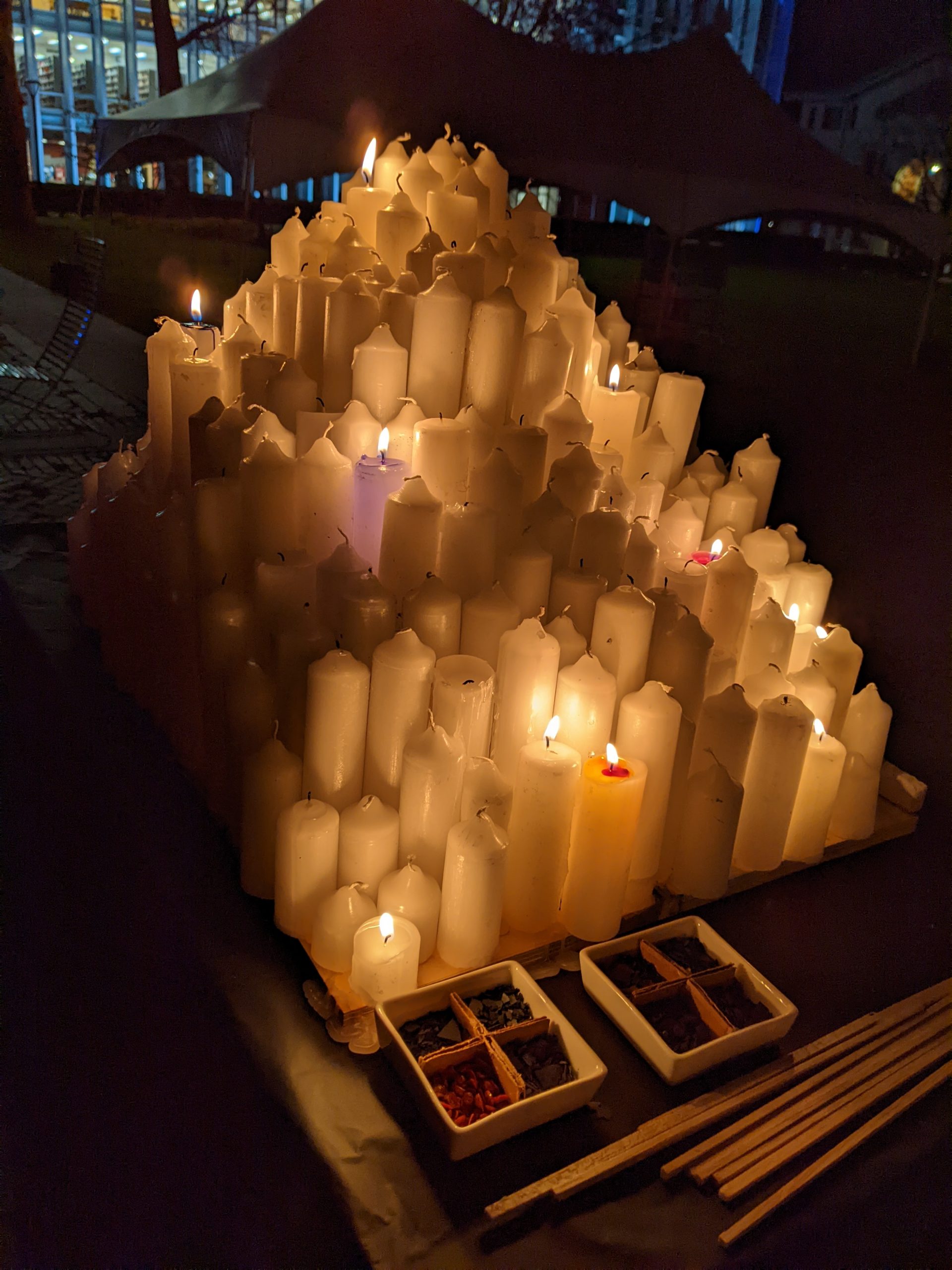 Dramatic shot of candle mountain with dye chips with the long matches